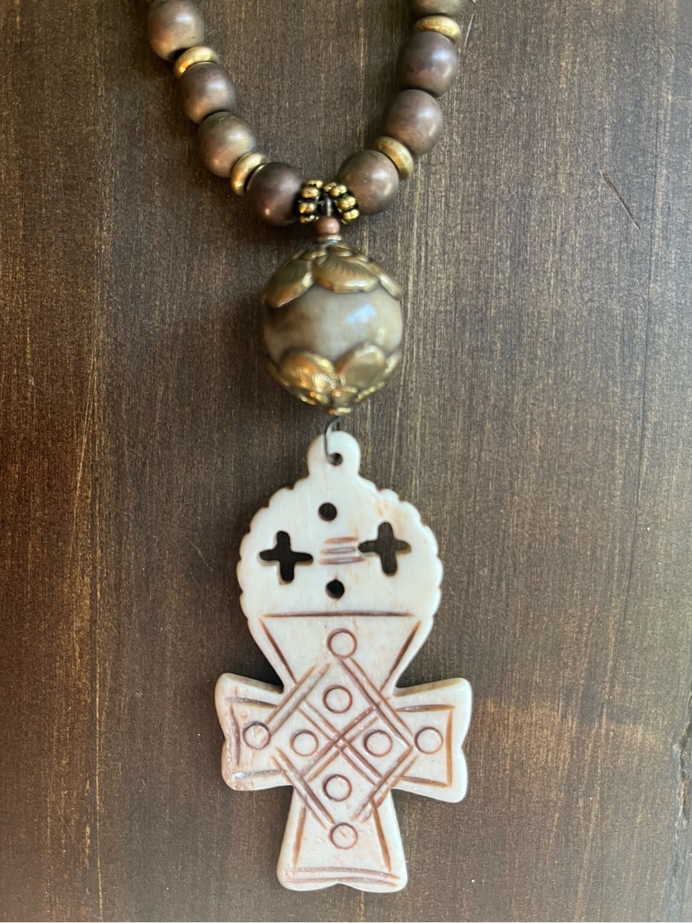Beautiful carved bone pendant with unique bronze hematite beads